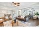 Open concept living and dining area with dark brown sofa and wooden floors at 2751 2Nd S Ave, St Petersburg, FL 33712