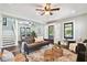 Open living room with dark brown sofa, wooden floors, and ceiling fan at 2751 2Nd S Ave, St Petersburg, FL 33712