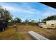 Large backyard with a wooden fence, and various outbuildings at 2809 49Th N St, St Petersburg, FL 33710