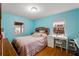 Bedroom with striped bedding, wood floors, and a workspace at 2809 49Th N St, St Petersburg, FL 33710