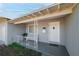 Quaint front porch with a white door and wrought iron railing at 2809 49Th N St, St Petersburg, FL 33710