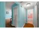 Hallway with light blue walls, wood flooring, and access to bathroom at 2809 49Th N St, St Petersburg, FL 33710