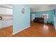 Living room with wood flooring, couch, and view into the kitchen at 2809 49Th N St, St Petersburg, FL 33710