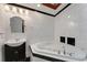 Bathroom with corner jacuzzi tub, dark vanity, and white tile at 2826 Kavalier Dr, Palm Harbor, FL 34684