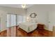 Bright bedroom featuring hardwood floors, king bed, and ample natural light at 2826 Kavalier Dr, Palm Harbor, FL 34684