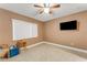 Spacious bedroom with large window and TV at 2826 Kavalier Dr, Palm Harbor, FL 34684