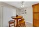 Cozy breakfast nook with round table and three wooden stools at 2826 Kavalier Dr, Palm Harbor, FL 34684