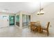 Dining room with glass top table and four chairs near window at 2826 Kavalier Dr, Palm Harbor, FL 34684