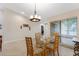 Bright dining room with glass table, chairs, and window view at 2826 Kavalier Dr, Palm Harbor, FL 34684