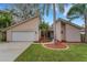 Modern home exterior with attached garage and landscaping at 2826 Kavalier Dr, Palm Harbor, FL 34684