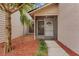 Front entrance with screened-in porch and red mulch landscaping at 2826 Kavalier Dr, Palm Harbor, FL 34684