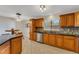 Eat-in kitchen with wood cabinets and granite countertops at 2826 Kavalier Dr, Palm Harbor, FL 34684