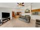 Living room with kitchen view, two sofas, and a ceiling fan at 2826 Kavalier Dr, Palm Harbor, FL 34684