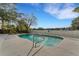 Refreshing rectangular pool with a concrete deck and white fence at 2826 Kavalier Dr, Palm Harbor, FL 34684