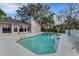 Inviting kidney-shaped pool in backyard with patio and fence at 2826 Kavalier Dr, Palm Harbor, FL 34684