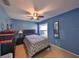 Bedroom with ceiling fan and gray bedding at 305 Crayford Pl, Valrico, FL 33594