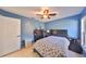 Bedroom with ceiling fan and gray bedding at 305 Crayford Pl, Valrico, FL 33594