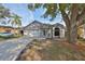 One-story house with a two-car garage and mature tree in front at 305 Crayford Pl, Valrico, FL 33594