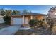 Orange house with white garage door and landscaping at 3101 E 23Rd Ave, Tampa, FL 33605