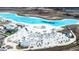 Aerial view of a lagoon with a sandy beach and lounge chairs at 31349 Cabana Rye Ave, San Antonio, FL 33576