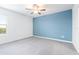 Bright bedroom featuring gray carpet and blue accent wall at 31349 Cabana Rye Ave, San Antonio, FL 33576