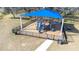 Modern playground with blue shade structure and safety fencing at 31349 Cabana Rye Ave, San Antonio, FL 33576