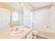 Clean bathroom with a tub, toilet, and vanity at 3440 Santa Rita Ln, Land O Lakes, FL 34639