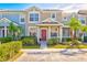 Two-story townhome with red door and landscaping at 3440 Santa Rita Ln, Land O Lakes, FL 34639