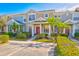 Two-story townhome with red door and landscaping at 3440 Santa Rita Ln, Land O Lakes, FL 34639