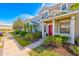 Two-story townhome with red door and landscaping at 3440 Santa Rita Ln, Land O Lakes, FL 34639