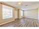 Living room with wood-look floors and window at 3440 Santa Rita Ln, Land O Lakes, FL 34639