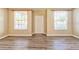 Bright living room with wood-look floors at 3440 Santa Rita Ln, Land O Lakes, FL 34639