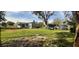 Spacious backyard with large grassy area and home in view at 35204 Ponderosa Rd, Zephyrhills, FL 33541