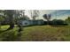 Single-story home with a yard and trees at 35204 Ponderosa Rd, Zephyrhills, FL 33541