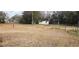 Empty lot with sparse grass and distant structures at 35204 Ponderosa Rd, Zephyrhills, FL 33541