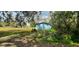 Blue storage shed in a grassy area with trees at 35204 Ponderosa Rd, Zephyrhills, FL 33541