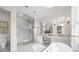 Elegant bathroom featuring a soaking tub, walk-in shower, and double vanity at 3571 Recurve Cir, Sarasota, FL 34240