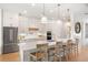 Island kitchen with white cabinets, quartz countertops, and breakfast bar seating at 3571 Recurve Cir, Sarasota, FL 34240