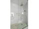 Spa-like shower with marble walls and a rainfall shower head at 3571 Recurve Cir, Sarasota, FL 34240