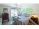 Spacious bedroom with a tropical mural and comfortable bed at 3710 41St S Way # C, St Petersburg, FL 33711