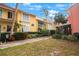 Inviting condo building with landscaped grounds and walkway at 3710 41St S Way # C, St Petersburg, FL 33711