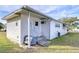 Side view of a white mobile home with covered patio and grill at 37418 Hammond Dr, Zephyrhills, FL 33541