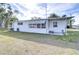 White mobile home with covered patio and screened enclosure at 37418 Hammond Dr, Zephyrhills, FL 33541