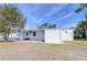 White mobile home with carport and partially covered patio at 37418 Hammond Dr, Zephyrhills, FL 33541