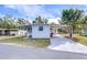 Front view of a white mobile home with carport at 37418 Hammond Dr, Zephyrhills, FL 33541