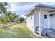 Side view of a mobile home with covered patio and fenced yard at 37418 Hammond Dr, Zephyrhills, FL 33541