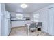 Small kitchen with white cabinets and a dining table at 37418 Hammond Dr, Zephyrhills, FL 33541