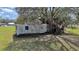 White mobile home with overgrown vegetation at 4001 Keene Rd, Plant City, FL 33565