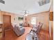 Living room with wood floors, wood walls, and comfy seating at 4001 Keene Rd, Plant City, FL 33565