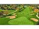 Aerial view of a lush green golf course with sand traps and water feature at 407 Lake Point Ct # 4E, Sun City Center, FL 33573